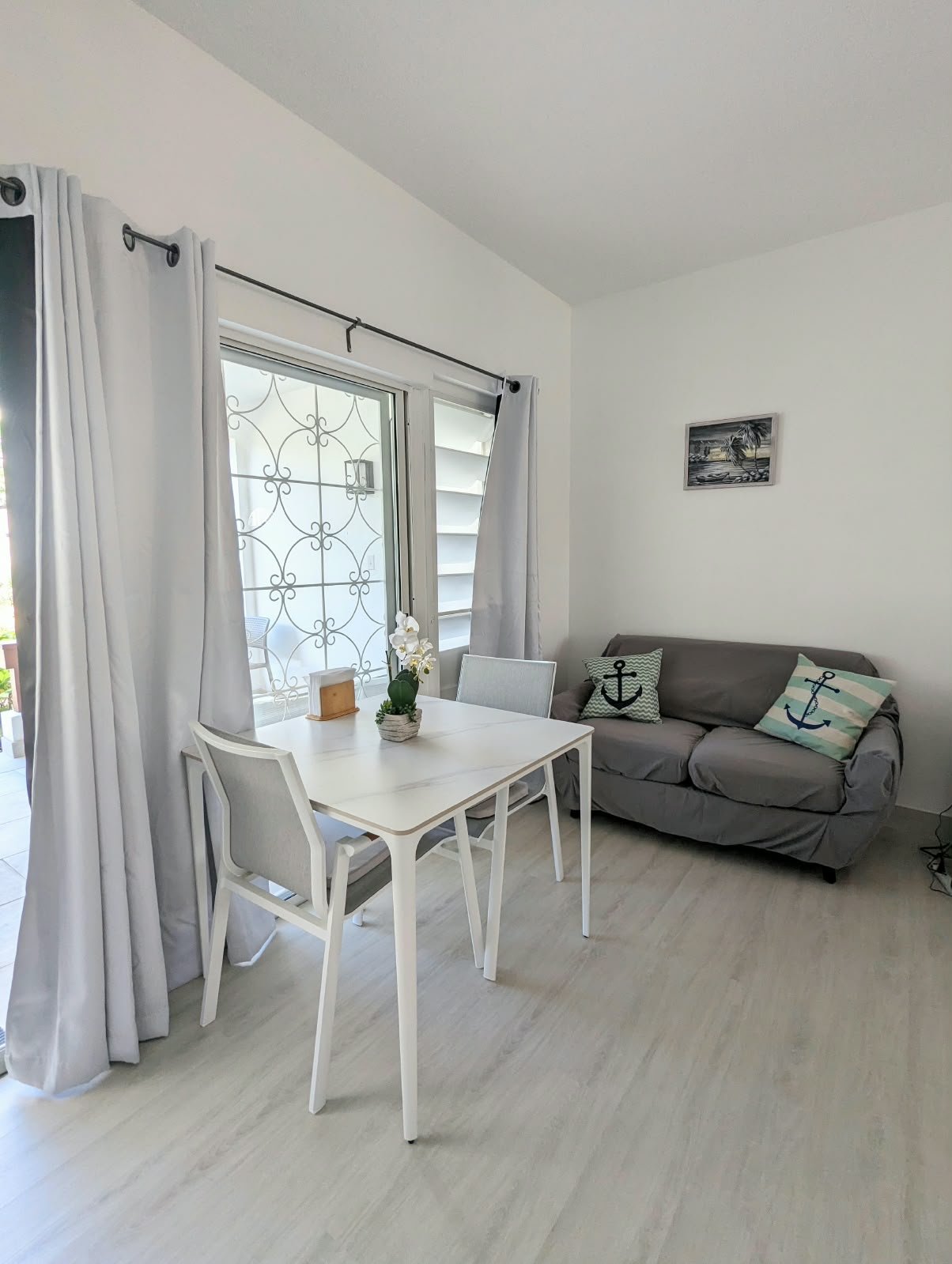 Living room and dining table, doors open to the patio